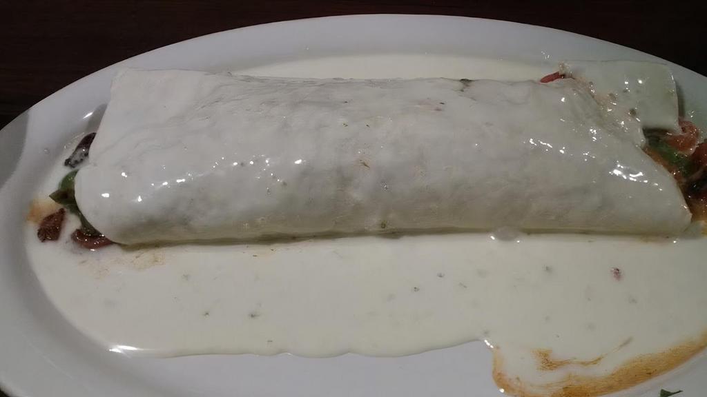 Burrito California · A 10 inch flour tortilla filled with your choice of grilled chicken or steak, rice, beans, sour cream, tomato, and lettuce, topped with cheese dip.