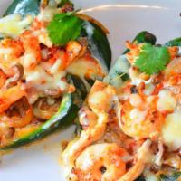 Chiles Poblanos Reales · New. Two poblano peppers filled with steak, chicken and shrimp cooked with onions, tomatoes,...