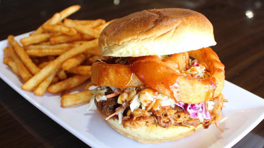 Sammie - Carolina Porker · Hand-pulled, oven-roasted pork cooked in one of our signature BBQ sauces, topped with coleslaw & onion rings, served on a toasted brioche bun.