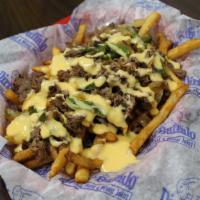 Philly Fries · No rolls necessary. Crispy fries topped with shaved sirloin, peppers and onions. What's a ph...
