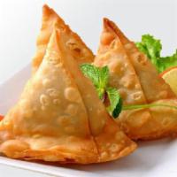Lamb Samosa · Turnover stuffed with ground lamb, peas and spices, served with tamarind sauce and onion chu...