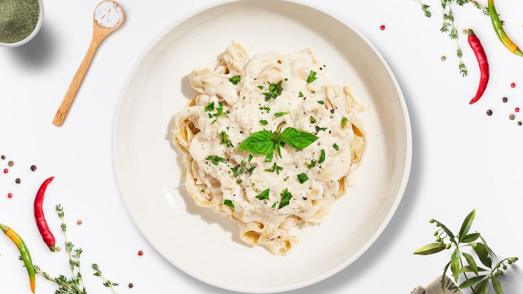 Fettuccine Alfredo · Fettuccine pasta cooked in creamy white sauce and aged parmesan.