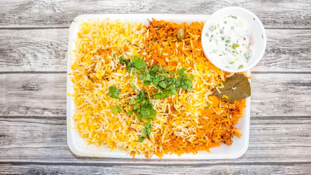 Chicken Biryani · Aromatic long grain basmati rice cooked over chicken meat marinated in yogurt and exotic spices then richly flavored with saffron.