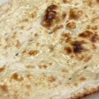 Butter Naan · Leavened fine flour bread, soft and fluffy cooked in a clay oven called a tandoor.