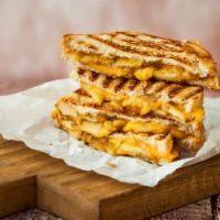 The Grilled Cheese Sandwich · Delicious cheese sandwich made with three slices of American cheese on an inverted bun and g...