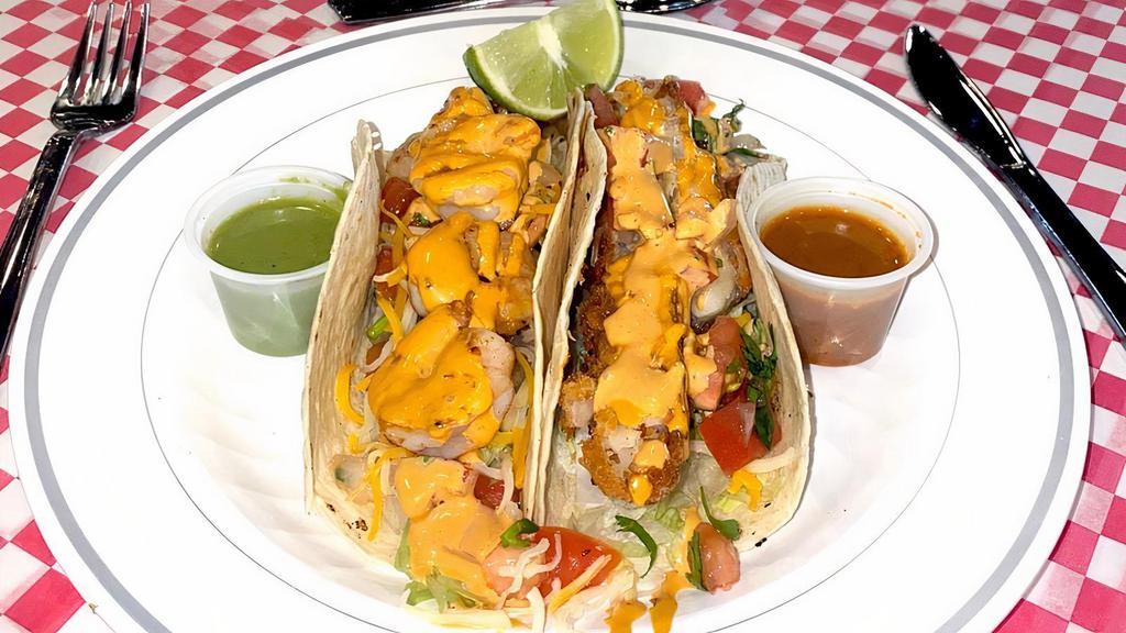 Shrimp Taco (Corn Tortilla) · Grilled shrimp and topped with grated cheese, lettuce, pico de gallo and our homemade chipotle mayo. Goes with side of salsas and lime wedges.
