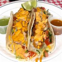 Fish Taco (Corn Tortilla) · Fried fish and topped with grated cheese, lettuce, pico de gallo and our homemade chipotle m...