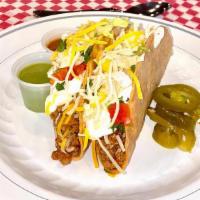 Crispy Taco (Corn Tortilla) · Choice of meat.  Topped  with grated cheese, lettuce, sour cream and pico de Gallo. Goes wit...