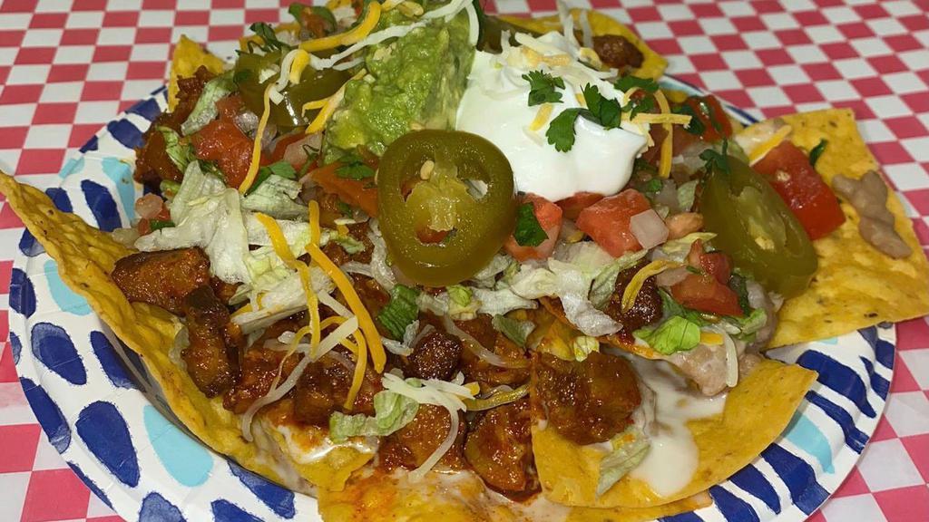 Nachos Supreme · Our fresh homemade Nachos are topped with choice of meat, re-fried beans, cheese dip, lettuce, pico de gallo, guacamole, sour cream, grated cheese and jalapeños. Goes with salsas on the side.