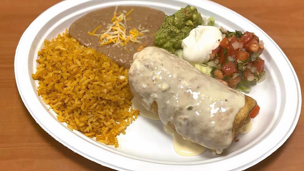 Chimichanga · Fried flour tortilla stuffed with choice of meat and grated cheese. Chimichanga is topped with cheese dip and Served with rice, refried beans and salad (lettuce, pico de Gallo, sour cream and guacamole). Goes with salsas on the side.