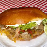 Tortas Mexicanas · Mexican bread stuffed with choice of meat, re-fried beans, grated cheese, lettuce, pico de g...