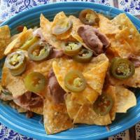 Cheese Nachos · Fresh tortilla chips covered with grated white cheese melted to perfection. Homemade refried...