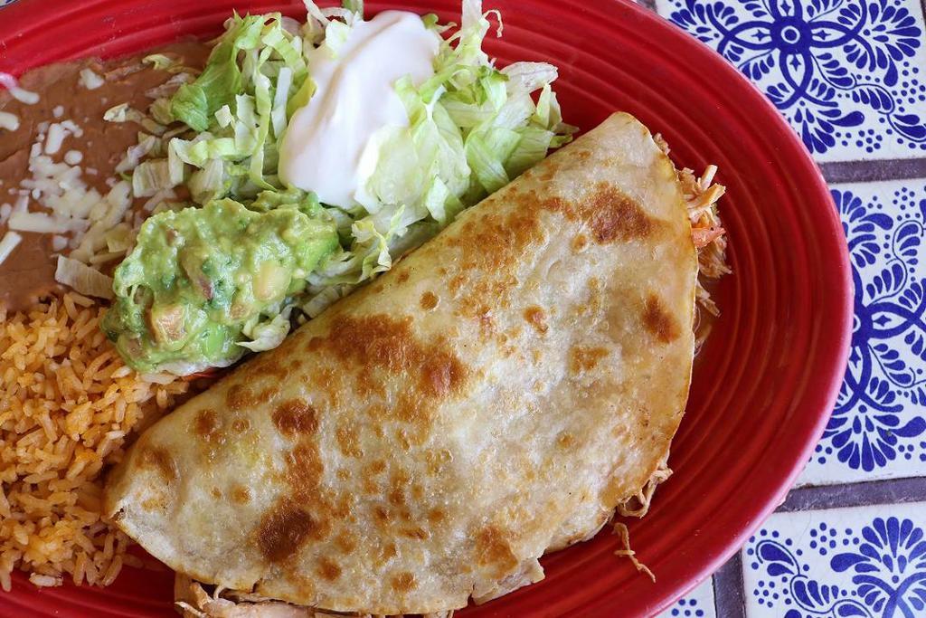 Quesadilla Special Shrimp · Grilled flour tortilla stuffed with shrimp, topped with lettuce, sour cream, and fresh guacamole and served with a side of fresh rice and homemade refried beans.