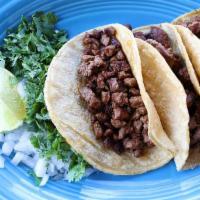 Tacos Carne Asada Meal · Three corn tortillas stuffed with sliced steak. Comes with a side of onions, cilantro, lime,...