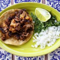 Taco Al Pastor (Each) · Corn tortilla filled with a traditional mix of savory grilled beef, pork, and pineapple. Oni...