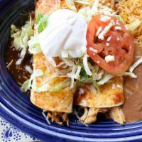 Burrito Deluxe · Two flour tortillas filled with juicy shredded chicken topped with sauce, lettuce, tomato,  ...