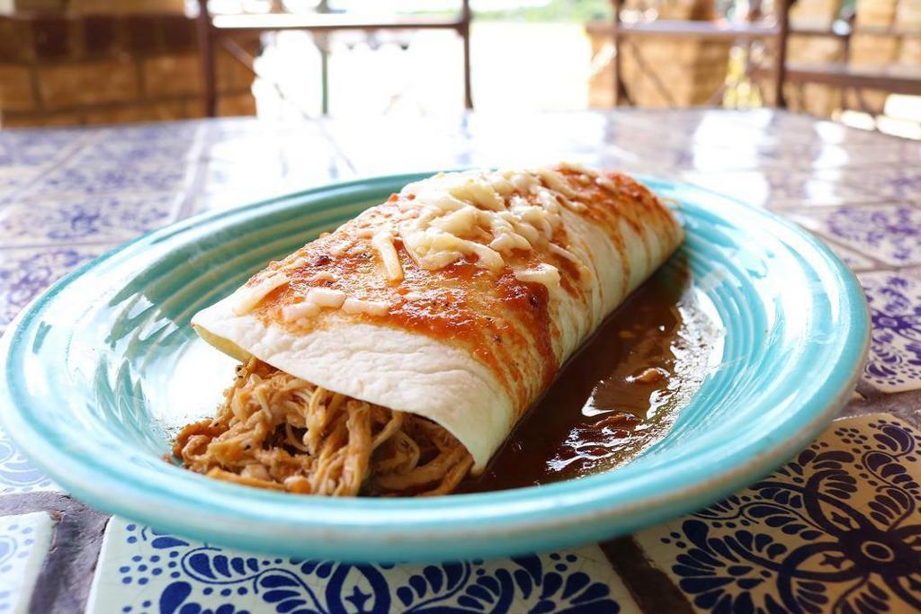 Burrito · A classic Mexican burrito filled with your choice of shredded chicken or ground beef, topped with burrito sauce and melted cheese.