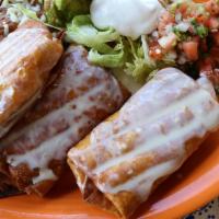 Chimichanga Supreme · Three flour tortillas: one chunk beef, one shredded chicken, and one shrimp, all topped with...