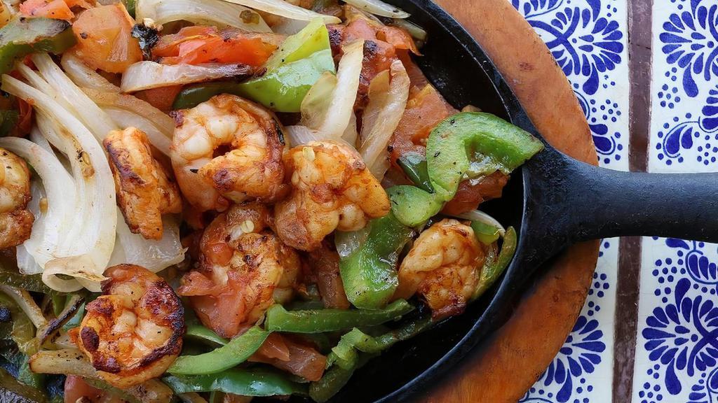 Shrimp Fajita · Delicious juicy shrimp, cooked with sauteed onions, bell peppers, and tomatoes. All fajitas come with a fajita salad and your choice of corn or flour tortillas.