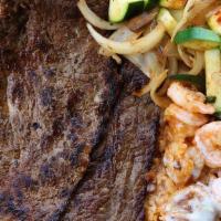 Steak And Shrimp · A delicious surf and turf option consisting of tender beef steak and shrimp on a bed of rice...