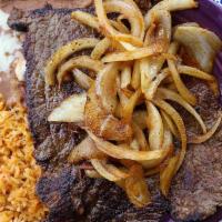 Carne Asada · A tender steak served with fresh rice and homemade refried beans, along with your choice of ...