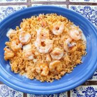 Shrimp Feliz · Juicy grilled shrimp seasoned to perfection and placed on a bed of fresh rice covered in our...