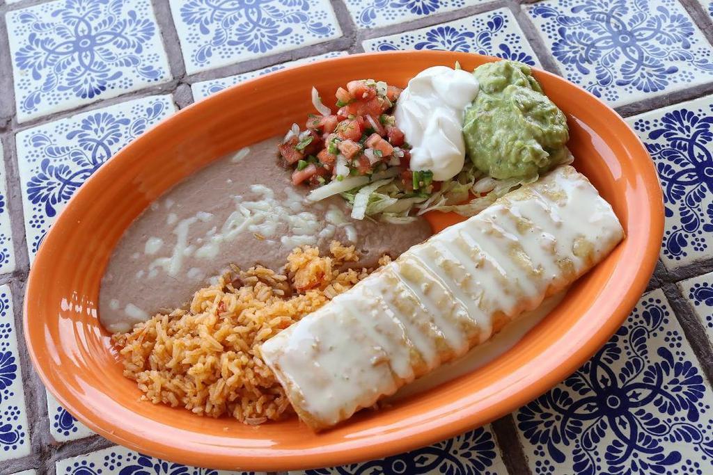 Lunch Chimichangas · Flour tortilla filled with your choice of tender chunk beef or shredded chicken, deep fried golden brown, topped with cheese sauce and served with a side of lettuce, sour cream, guacamole, pico de gallo, fresh rice and homemade refried beans.