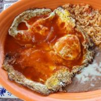 Lunch Huevos Rancheros · A traditional Mexican dish of over easy eggs topped with a savory red sauce served with fres...