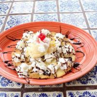 Sopapilla With Ice Cream · A delicious fried flour tortilla topped with a scoop of soft vanilla ice cream, honey, cinna...