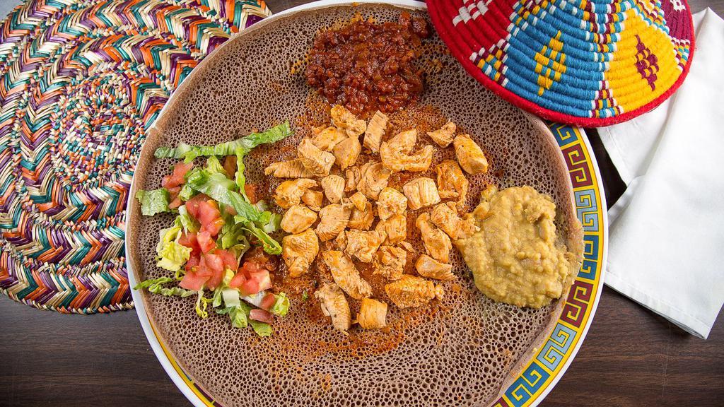 #10. Chicken · Served with two choices of vegetables alitcha, timtimo or hamley with 1 injera. Chicken cubes sautéed with pepper, onion and spices. Choice of spicy or not spicy.