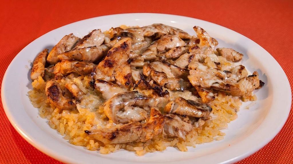 Arroz Con Pollo · Grilled chicken strips on a bed of rice covered in cheese sauce