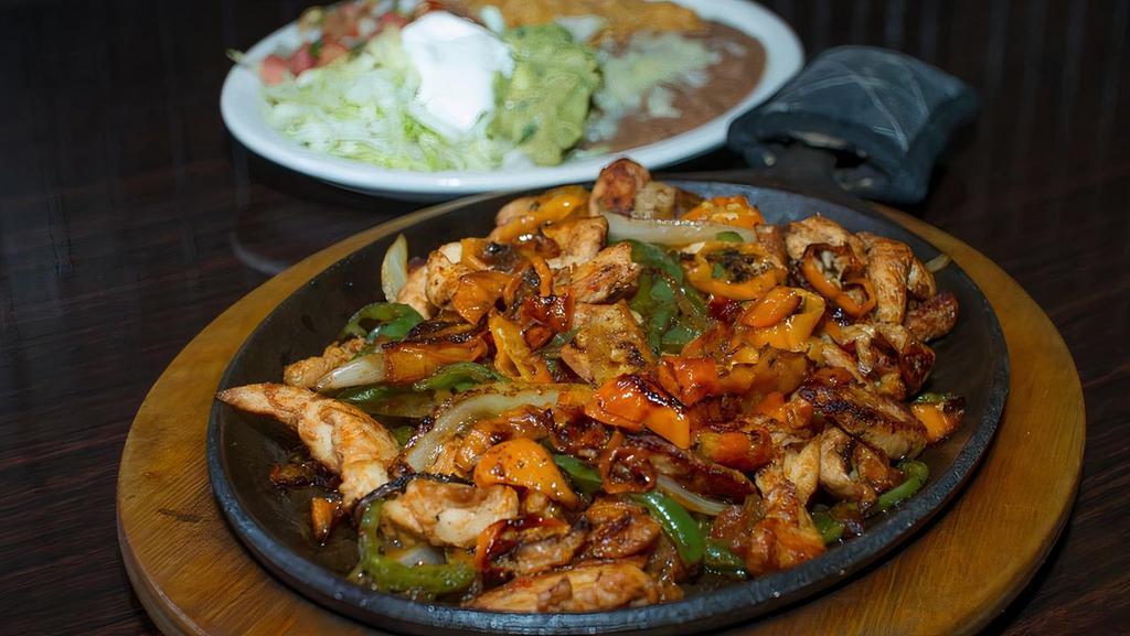 La Parrilla Fajitas · Grilled onions, bell peppers, tomatoes, chicken or steak Served with rice & beans, lettuce, sour cream, guacamole, pico de gallo, and tortillas