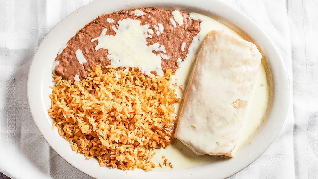 La Parrilla Burrito · Flour tortilla stuffed with onions, bell peppers, and tomatoes, and covered with queso. Served with rice & beans. grilled chicken or steak