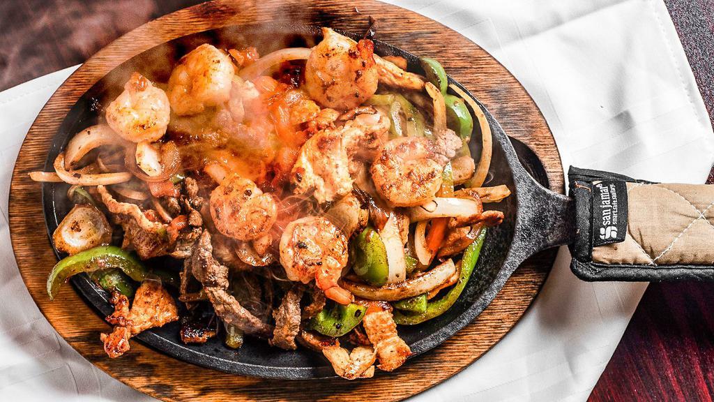 La Parrilla Fajitas · Grilled onions, bell peppers, tomatoes, chicken, steak, and
shrimp. Served with rice & beans, lettuce, sour cream,
guacamole, pico de gallo, and tortillas.