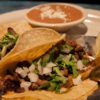 Tacos Authenicos · Three soft corn tortillas filled with cilantro and chopped onions and green onions. Served w...