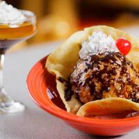 Deep Fried Ice Cream · Breaded scoop of ice cream deep fried and covered with whip cream and chocolate syrup.