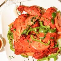 Tandoori Chicken · Chicken marinated in exotically spiced yogurt and cooked to perfection in a tandoor oven.