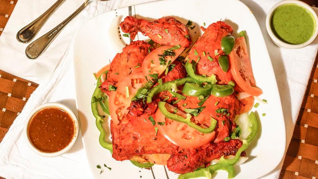 Tandoori Chicken · Chicken marinated in exotically spiced yogurt and cooked to perfection in a tandoor oven.
