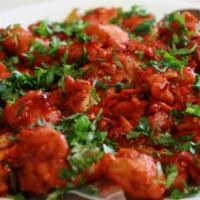 Chicken 65 · Boneless chicken marinated in yogurt cooked with curry leaves and spices.