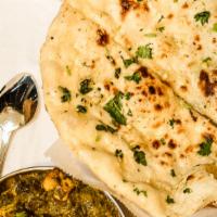 Garlic Naan · White flour bread topped with garlic and parsley, cooked in a clay oven.
