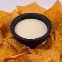 Cheese Dip · Our famous cheese blend 8oz served with a large bag of chips