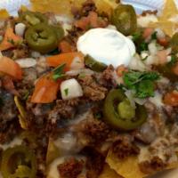 Super Nachos · Crispy homemade corn tortilla chips  topped with your choice of refried pinto beans or black...