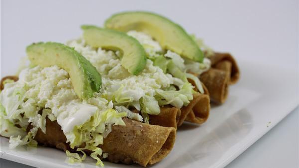 Flautas · Four crispy, rolled- up corn taquitos stuffed with shredded chicken, topped with refried pinto beans, lettuce, sour cream, queso fresco and avocado slices.