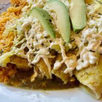 Enchiladas Verdes O Rojas · Four green or red enchiladas dipped in salsa and stuffed with shredded chicken and topped wi...