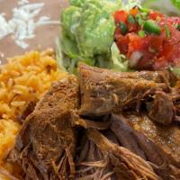 Carnitas / Pulled Pok  · Tender, grilled pulled-pork served with refried pinto beans, rice, fresh guacamole, sour cre...