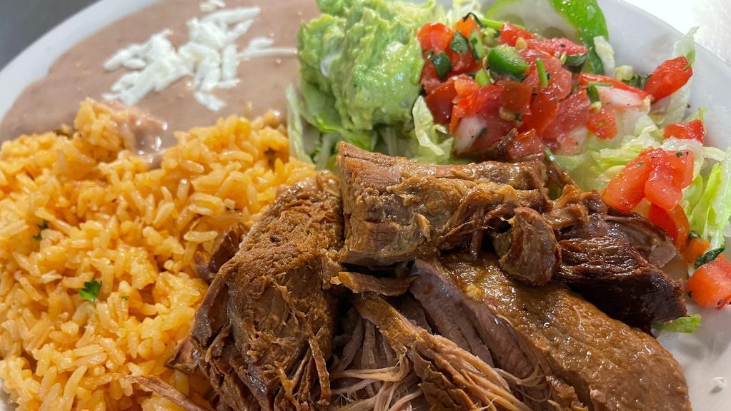 Carnitas / Pulled Pok  · Tender, grilled pulled-pork served with refried pinto beans, rice, fresh guacamole, sour cream, lettuce and pico de gallo. Accompanied with your choice of flour or corn tortillas.