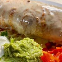 Chimichanga · A deep-fried burrito prepared with your choice of meat and topped with melted cheese. Served...