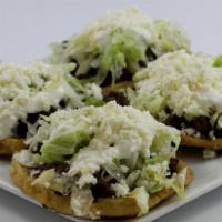 Sopes (3) · Three fried homemade corn base patties. Served with your choice of meat and topped with refr...