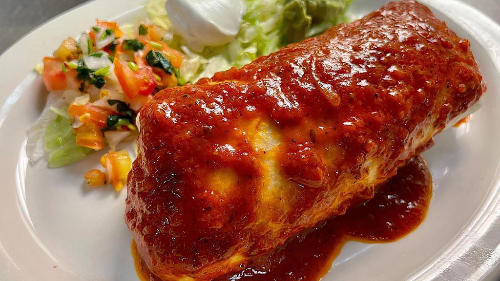 Burrito · Stuffed with rice, refried pinto beans, grilled onions and bell peppers, topped with our homemade salsa roja and served with your choice of meat, lettuce, pico de gallo, sour cream and fresh guacamole.