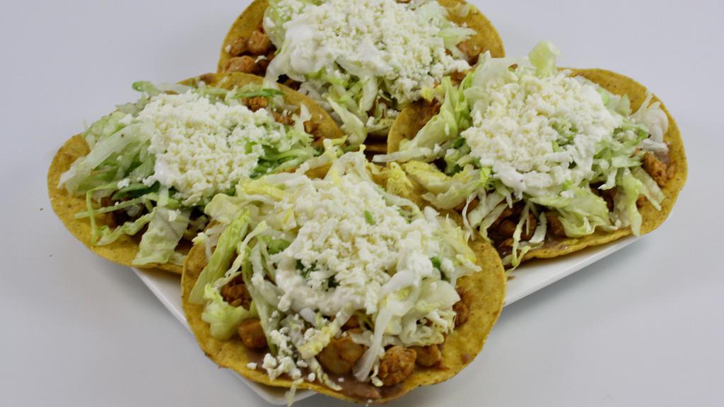 Tostadas (3) · Three corn tortilla base fried pinto beans, lettuce, sour cream, queso fresco and your choice of meat.